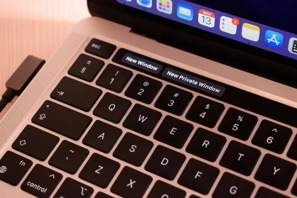 Close-up of a laptop keyboard with on-screen shortcut buttons for a new window and a new private window