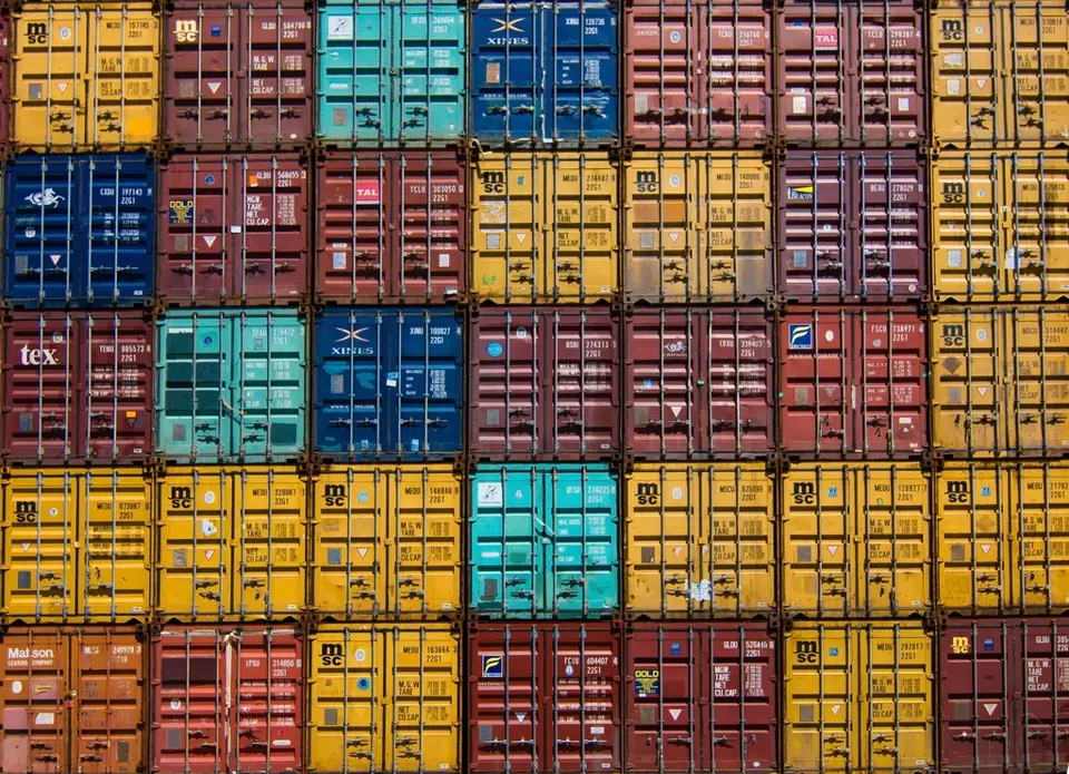 Rows of colourful stacked shipping containers, a visual metaphor for Microsoft Execution Containers keeping each AI agent in its own box